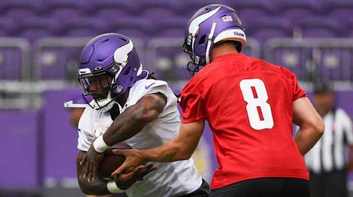 Jul 29, 2022; Minneapolis, MN, USA; Minnesota Vikings quarterback Kirk Cousins (8) hands off to running back Dalvin Cook (4) during training camp at US Bank Stadium.